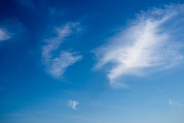 A clear blue sky with clouds. A blue sky background.