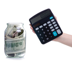 Money dollars bank notes in glass jar and calculator isolated on white background, concept save money