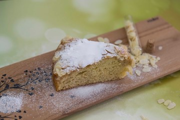 pieces of German butter cake with almonds on the wooden table