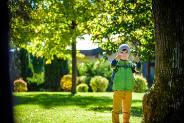 portrait of young kid running and smiling in the park