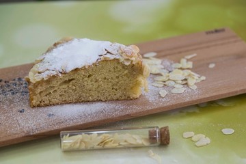 pieces of German butter cake with almonds on the wooden table
