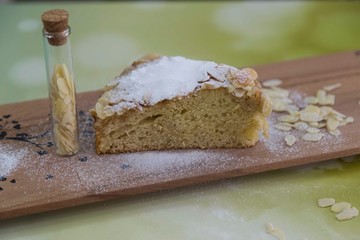 pieces of German butter cake with almonds on the wooden table