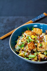 Vegan salad with crispy tofu, red and wild rice and mango