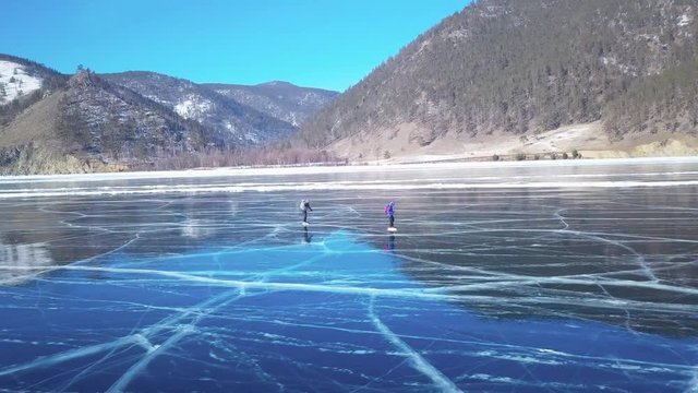 Tourists on the ice from aerial view. Winter in Siberia, Baikal Lake.