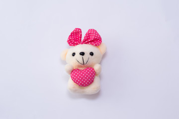 children's soft toy teddy bear girl with heart isolated on white background