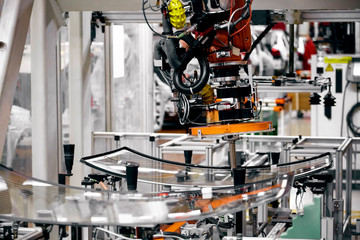 In the automotive production line, the automated robotic arm for automotive glass coating is working.