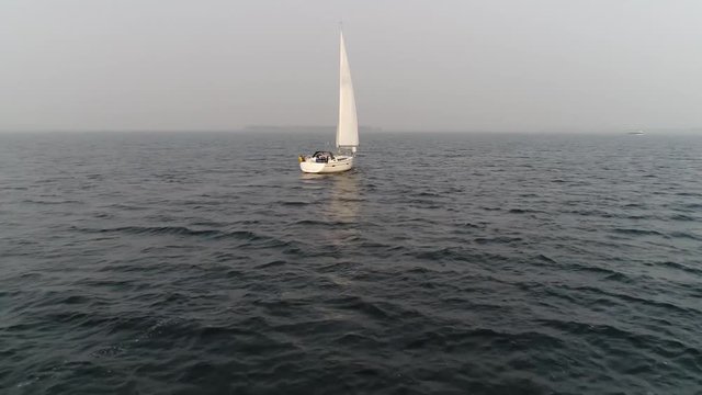 Aerial flyby past two sloops are sailing boats with single mast and fore-and-aft rig plus one head-sail the most common setup of modern sailboats is the Bermuda-rigged configuration 4k high resolution