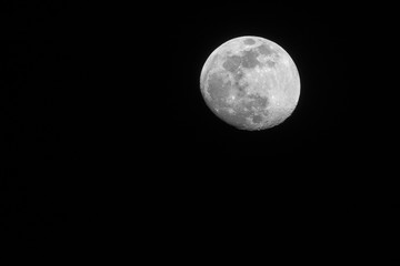 almost full moon on a dark night sky