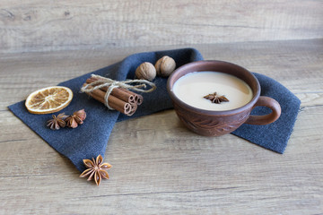 Traditional indian drink - masala tea with spices on wooden background