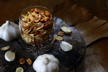Toasted peanuts and fried garlic chips on a glass