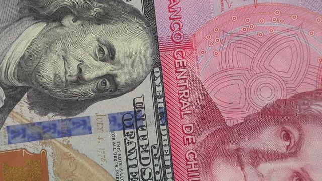 Chile peso against US dollar bill rotating. Chile and USA trade. 4K stock video footage