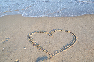 Love message on the beach sand - vacation and travel concep