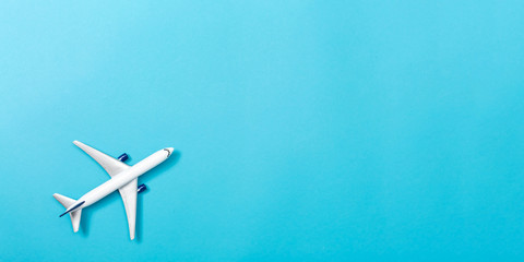 A toy airplane on a blue paper background