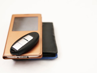 Man's accessories: car key, smart-phone, leather wallet. Concept: things man use everyday.