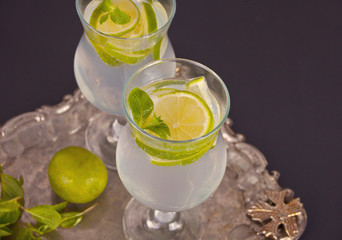 Lemonade or mojito cocktail with lemon and mint, cold refreshing drink or beverage
