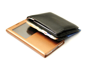 Man's wallet with cash and smart phone on a light background. Things man use every day.