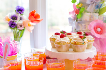 Dessert table with cupcakes and flowers Easter party theme