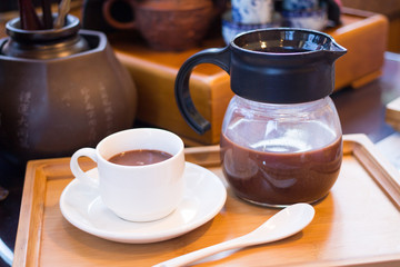 Obraz na płótnie Canvas hot dark milk chocolate cup with teapot