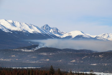 Fototapeta na wymiar Smoke Rising Over The Mountains, Jasper National Park, Alberta