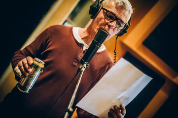 Behind scene. Famous alternative male singer practice singing on microphone