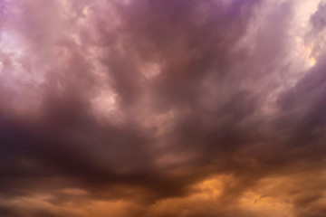 Naklejka na ściany i meble Dramatic sky with purple and orange clouds