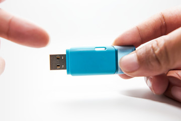 Digital data memory concept.Hand holding pendrive on white background