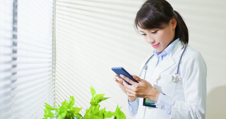 asian doctor use smart phone