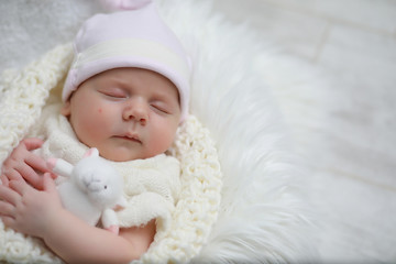 Fototapeta na wymiar Baby newborn sleeping wrapped up in a blanket