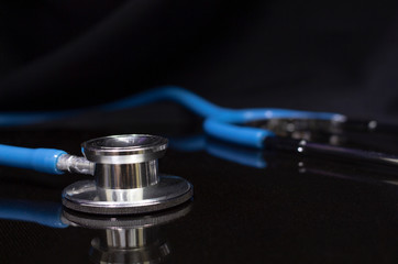 Blue stethoscope on black background