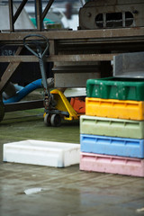 Fototapeta premium Colorful boxes in the fishing industry, fish market, forklift in warehouse