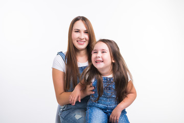 Parenting, family and children concept - Portrait of a mother and her baby girl have fun and smiling over white background