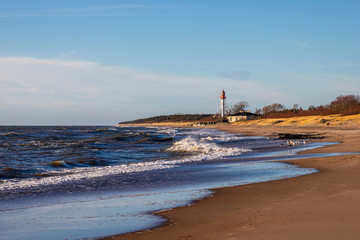 an old lighthouse stands on the shore of the sea