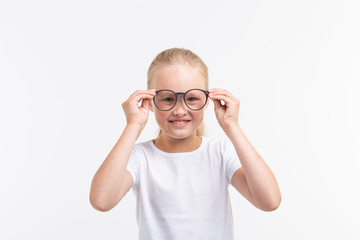 Beautiful child girl with glasses isolated on white