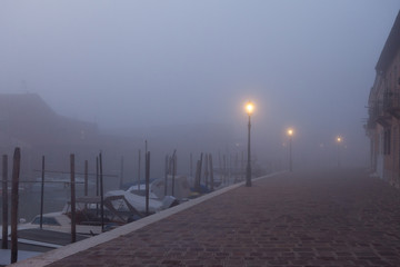 Fototapeta na wymiar Night view canal on Murano island in the fog