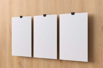 Blank paper poster hanging on binder clip