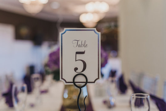 Wedding Reception table number five place card on puple table setting