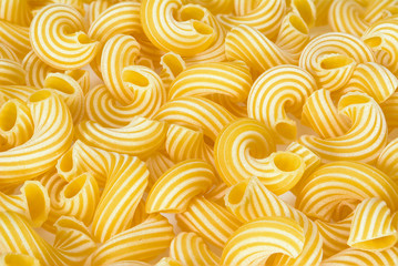 Dry uncooked cavatappi italian pasta full background.