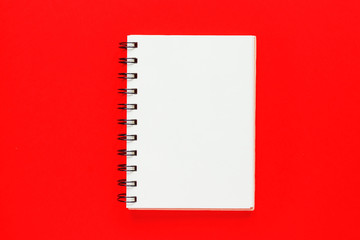 Top view of open empty notebook on bright red colorful background