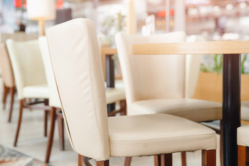 White chairs with wooden structure in interior restaurant