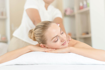 Fototapeta na wymiar Beautiful young woman relaxing with hand massage at beauty spa. Body massage. Closed up of young beautiful woman getting spa massage treatment at beauty spa salon.