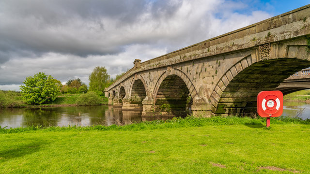 A lifebuoy at Atcham Old Bridge over the River Severn in Atcham, near Shrewsbury, Shropshire, England, UK