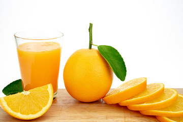 Orange juice and oranges with leaves
