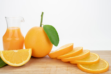Orange juice and oranges with leaves