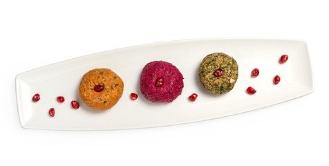 Appetizer of cheese and vegetables on a plate, top view, on a white background