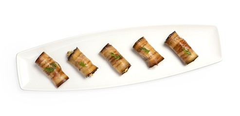 Appetizer of eggplants with cheese on a plate, top view, on a white background