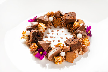 creative dessert with brownie and edible flowers