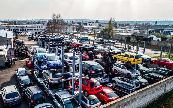 Lines of crushed cars wreck in scrapyard before being shredded recyling