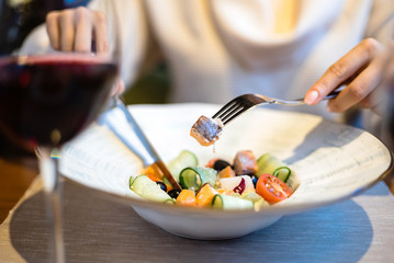 woman eating green healthy greek salad