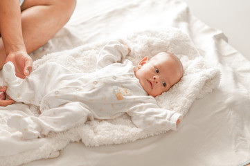 Cute baby boy in a white light bedroom Newborn baby is cute. In bedding for children born - images