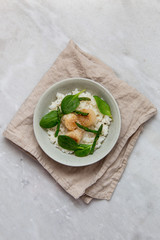 scallop risotto with asparagus, spinach in rustic plate on marble background with copy space